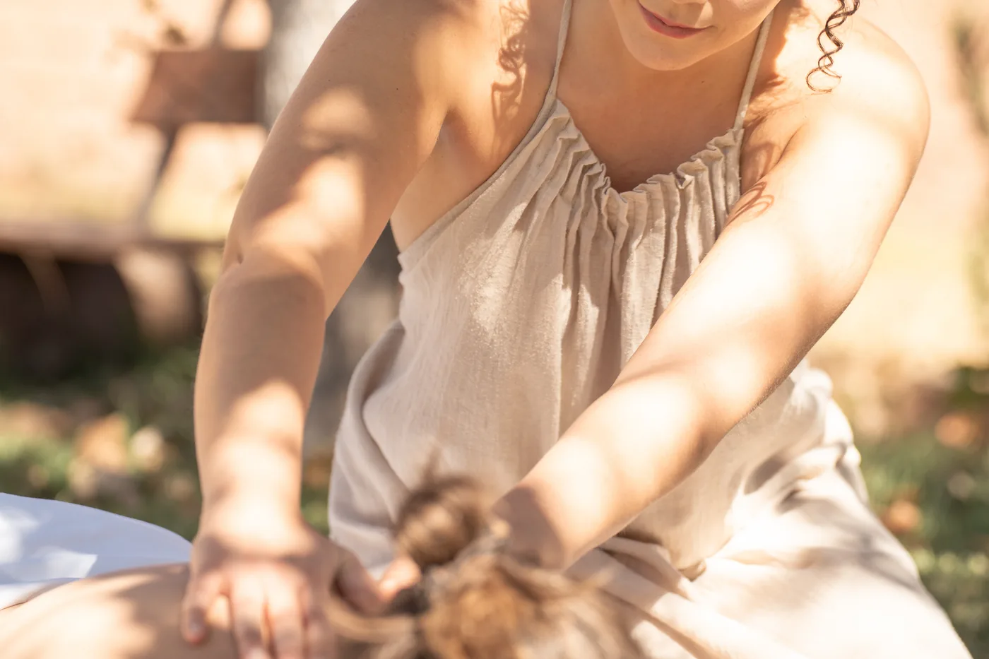 Massage therapist working oil into a client's back